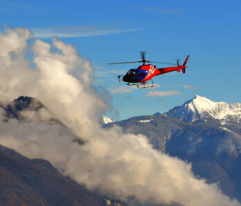 helicopter-flying-among-clouds-snow-capped-mountains-min_small